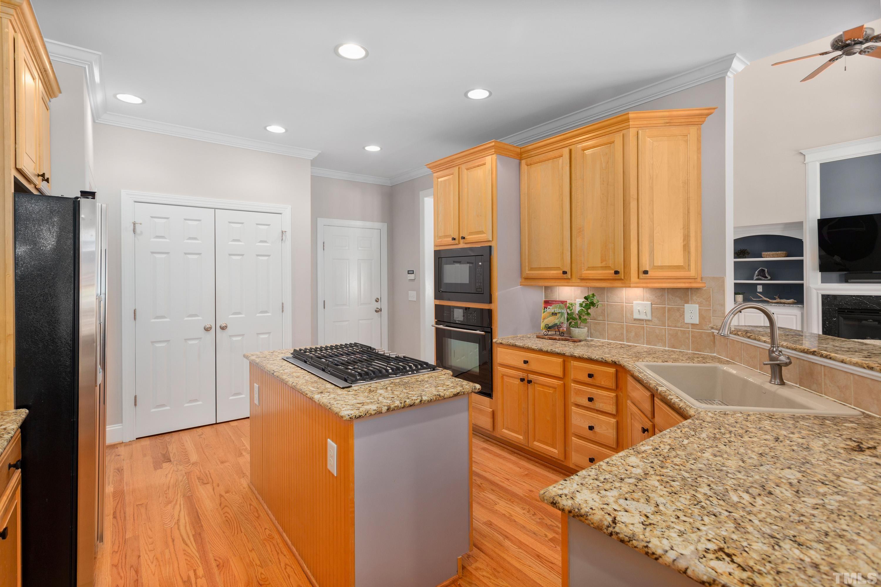 3728 Grandbridge Drive Apex, NC 27539 - Photo 19 of 76 a kitchen with stainless steel appliances granite countertop a sink stove and refrigerator