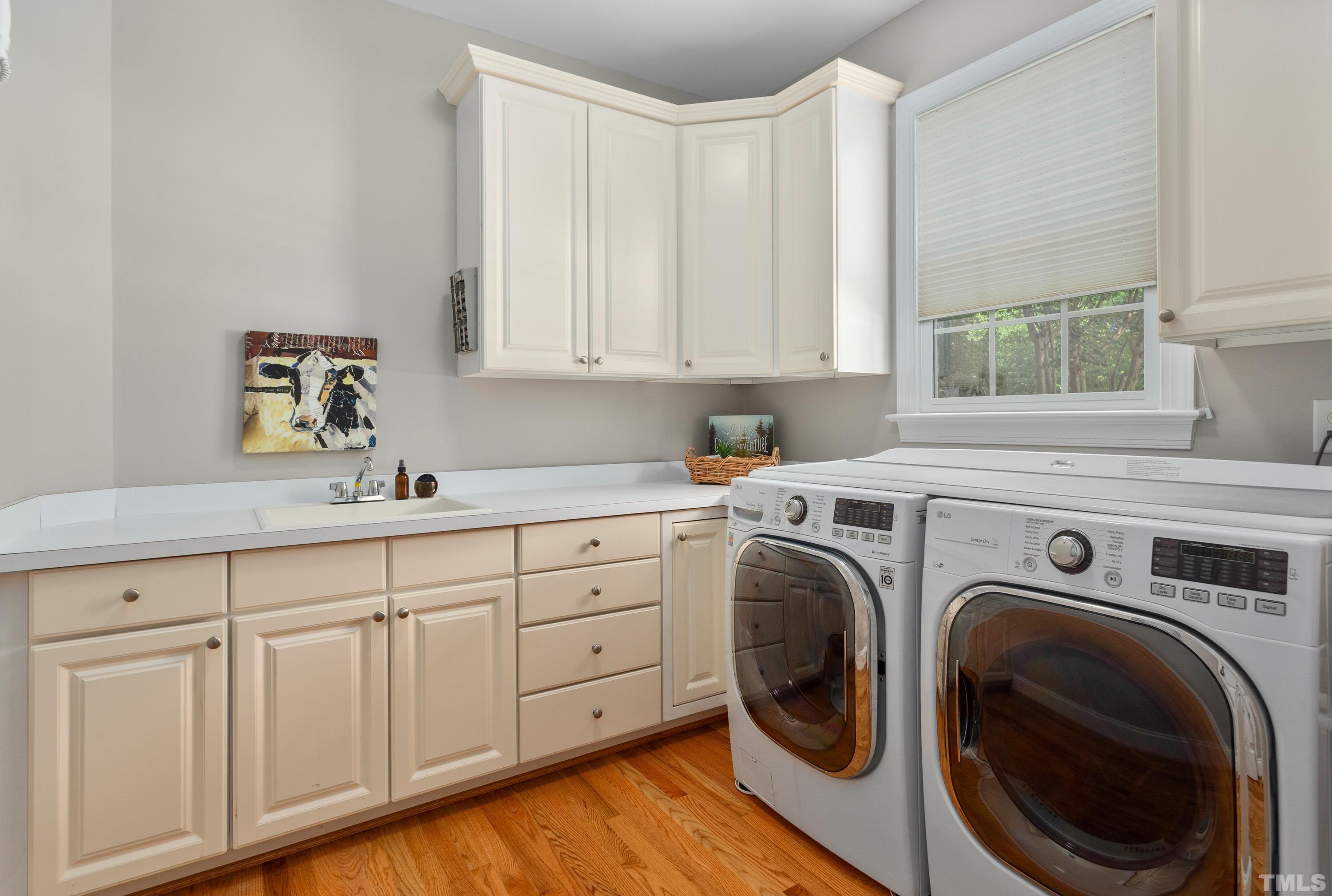 3728 Grandbridge Drive Apex, NC 27539 - Photo 28 of 76 a utility room with sink dryer and washer