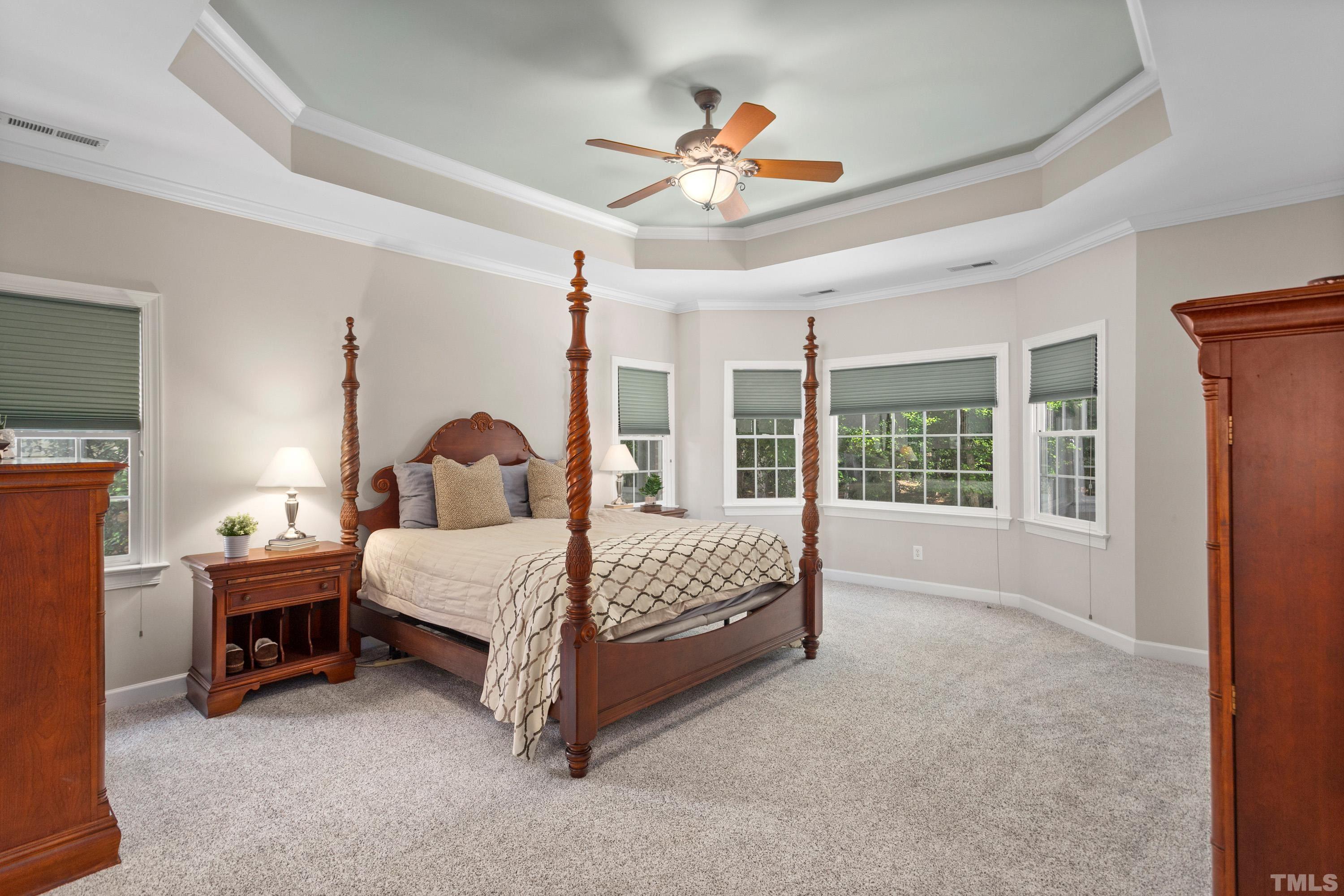 3728 Grandbridge Drive Apex, NC 27539 - Photo 36 of 76 a bed room with a bed and a chandelier