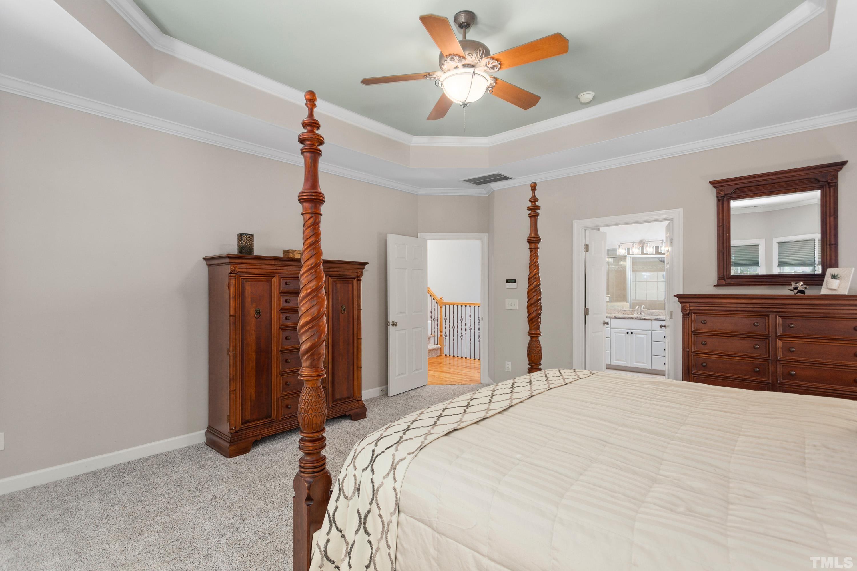 3728 Grandbridge Drive Apex, NC 27539 - Photo 37 of 76 a bedroom with a bed and a chandelier