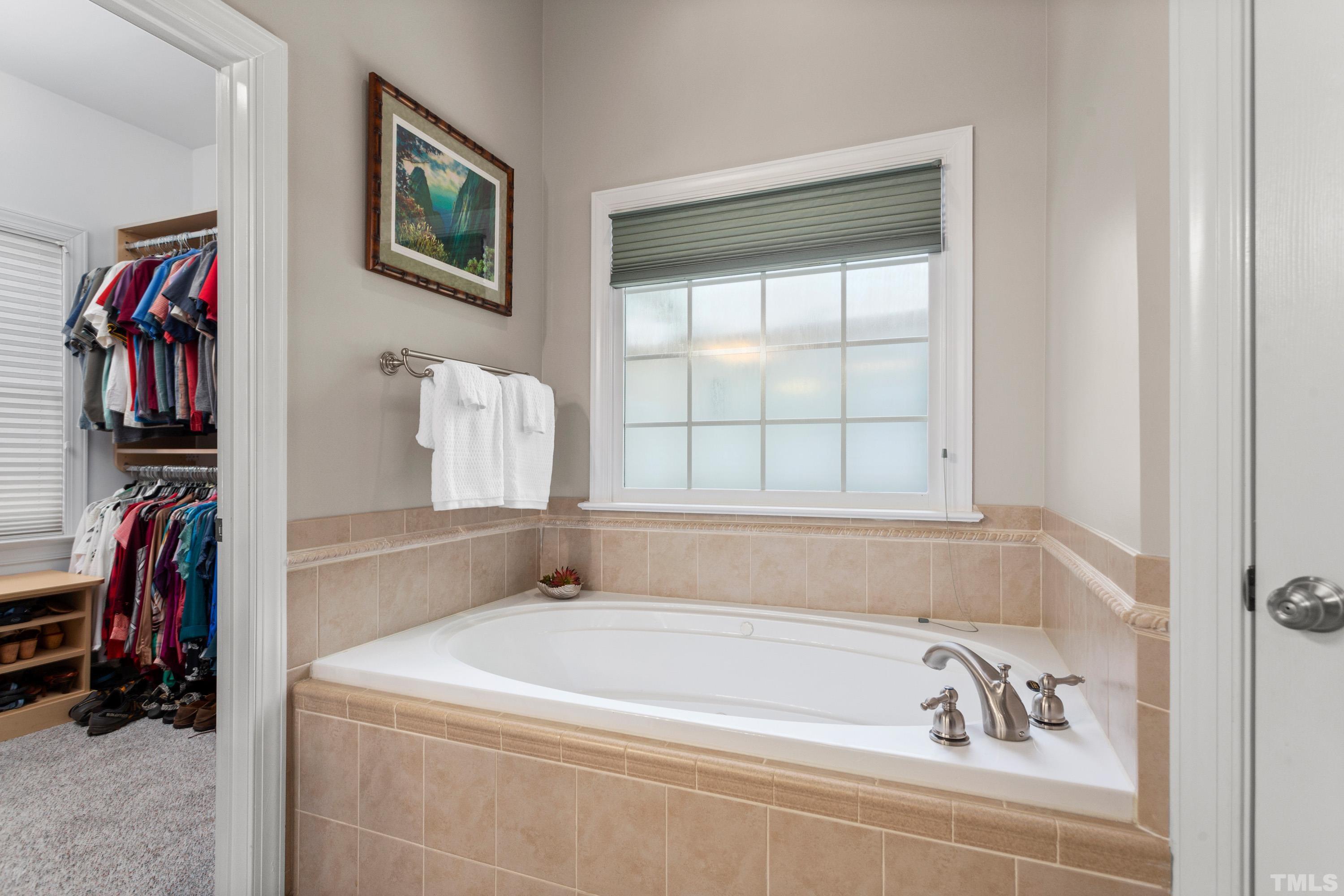 3728 Grandbridge Drive Apex, NC 27539 - Photo 40 of 76 a bathroom with a tub and a window