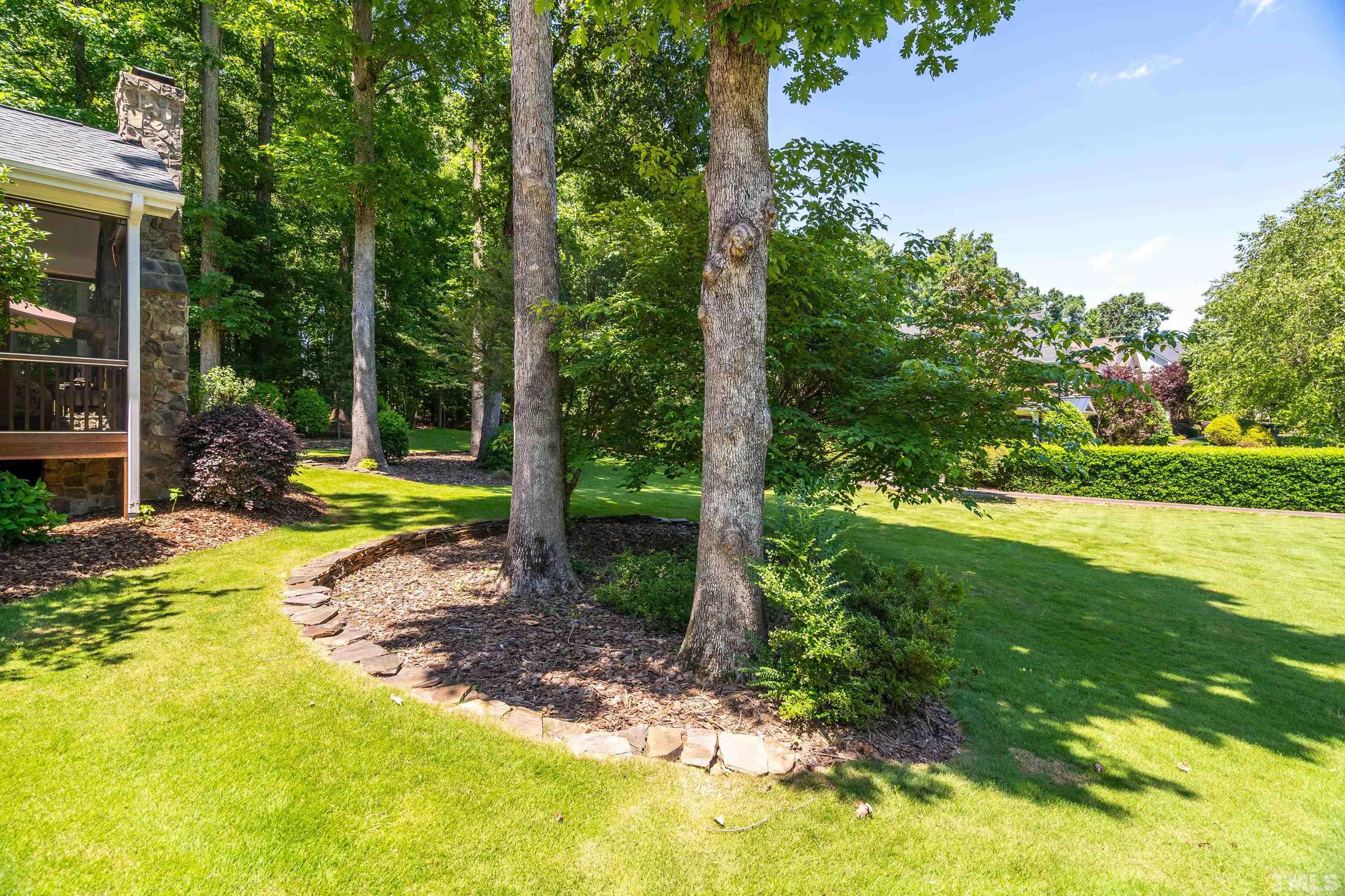 3728 Grandbridge Drive Apex, NC 27539 - Photo 50 of 76 a view of a yard with plants and garden