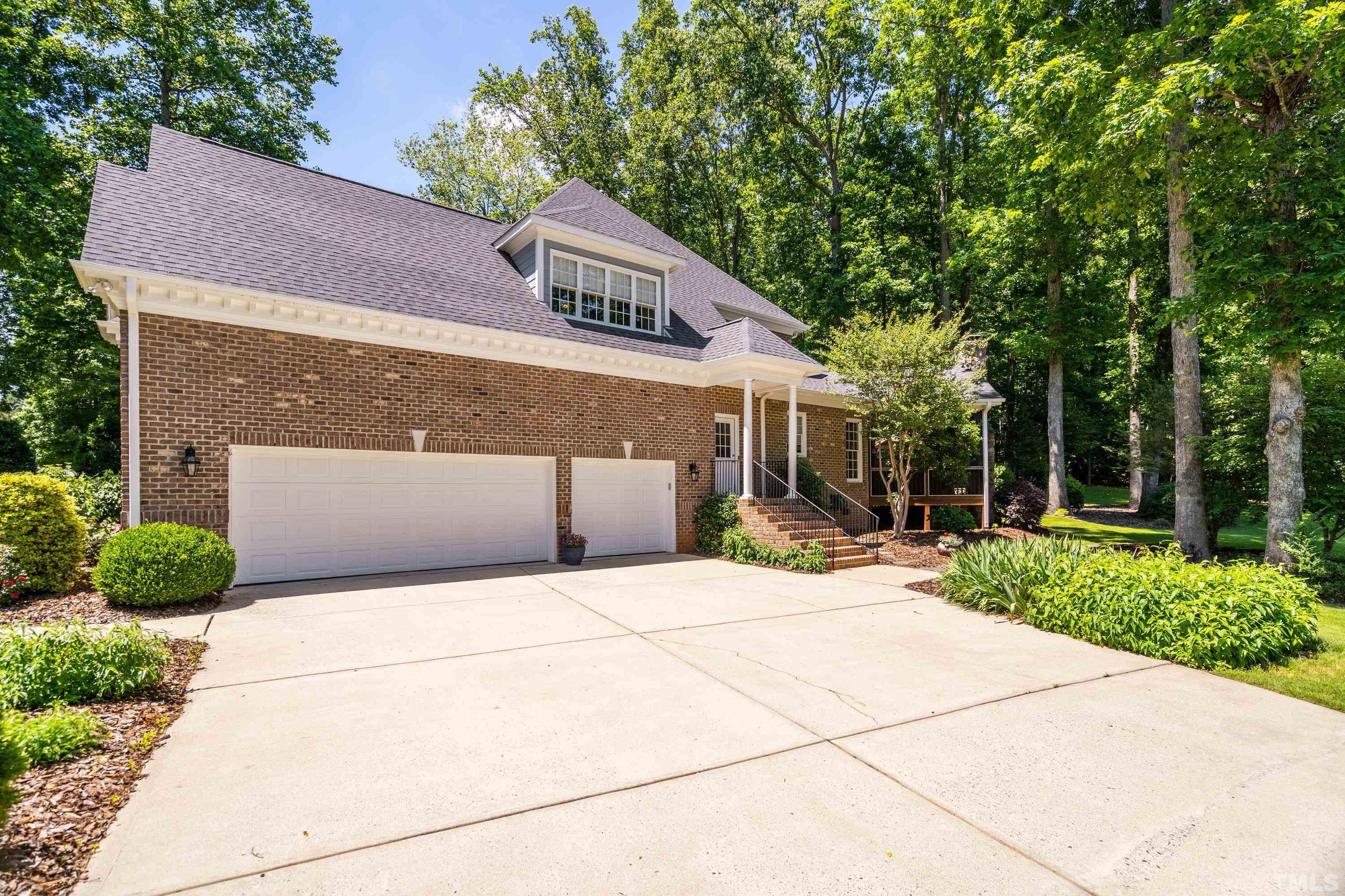 3728 Grandbridge Drive Apex, NC 27539 - Photo 5 of 76 a front view of a house with a yard and potted plants