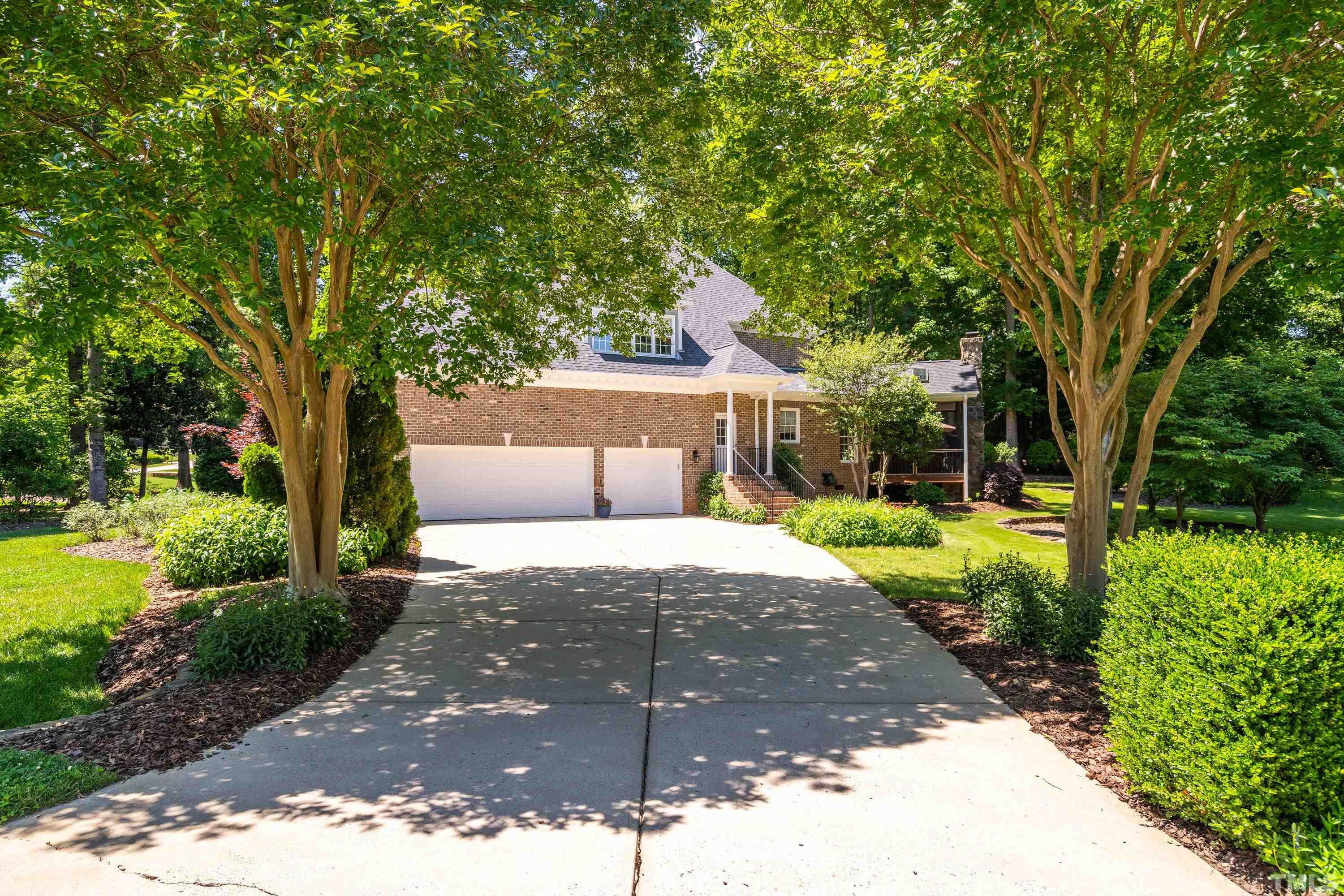 3728 Grandbridge Drive Apex, NC 27539 - Photo 6 of 76 a view of backyard with large trees and plants