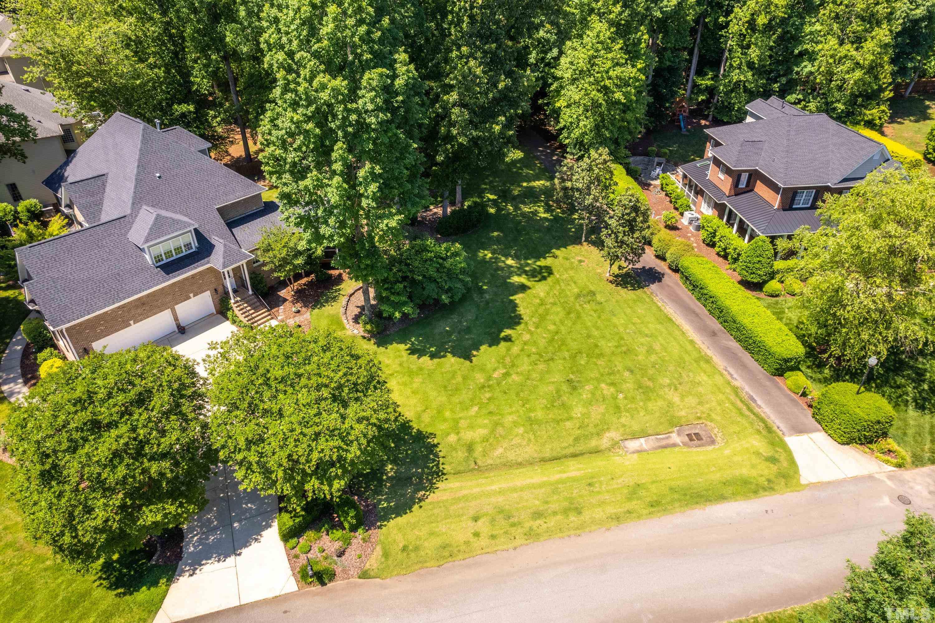 3728 Grandbridge Drive Apex, NC 27539 - Photo 72 of 76 an aerial view of residential house with swimming pool and lawn chairs under an umbrella