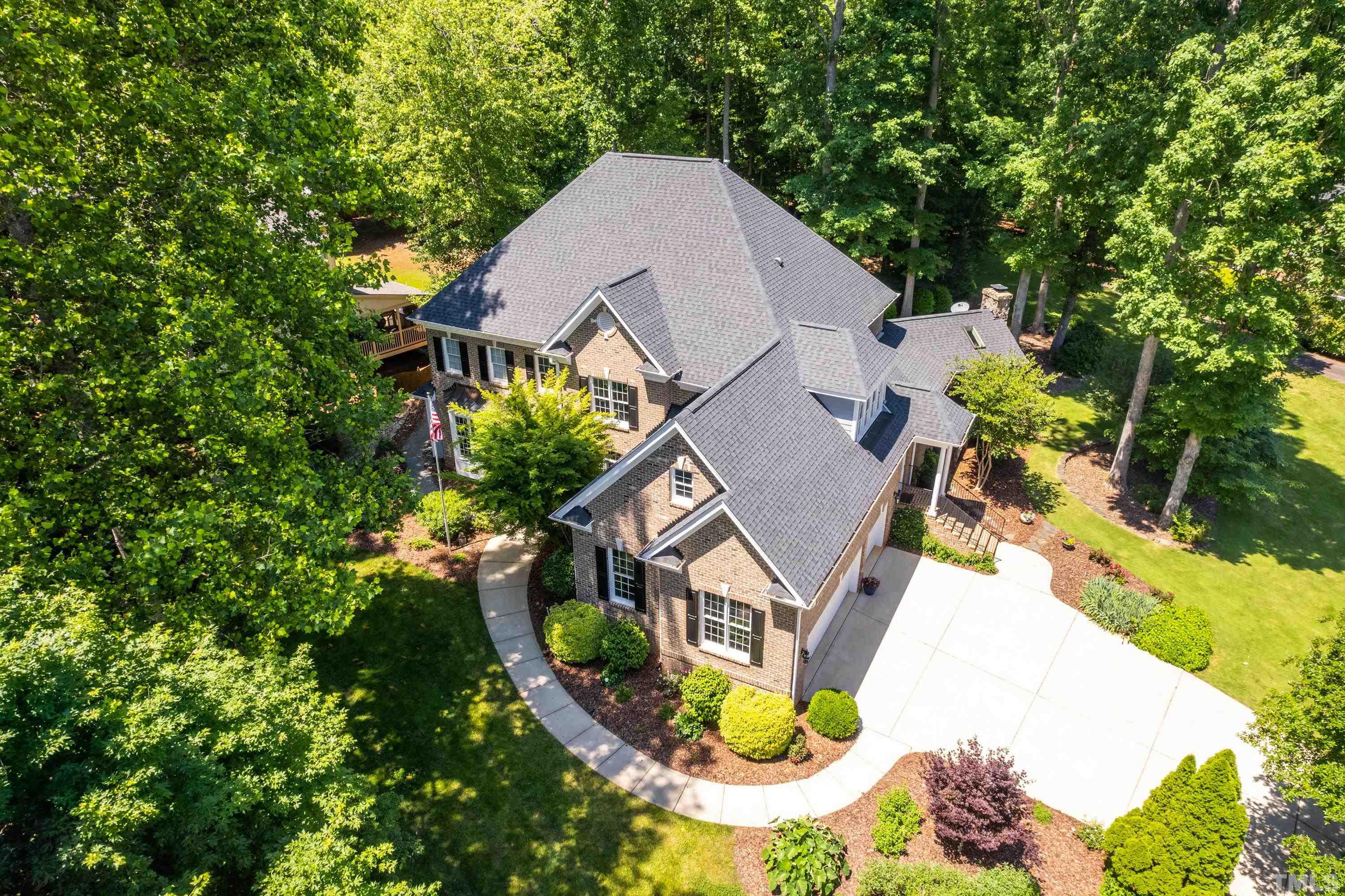 3728 Grandbridge Drive Apex, NC 27539 - Photo 74 of 76 an aerial view of a house with swimming pool and large trees