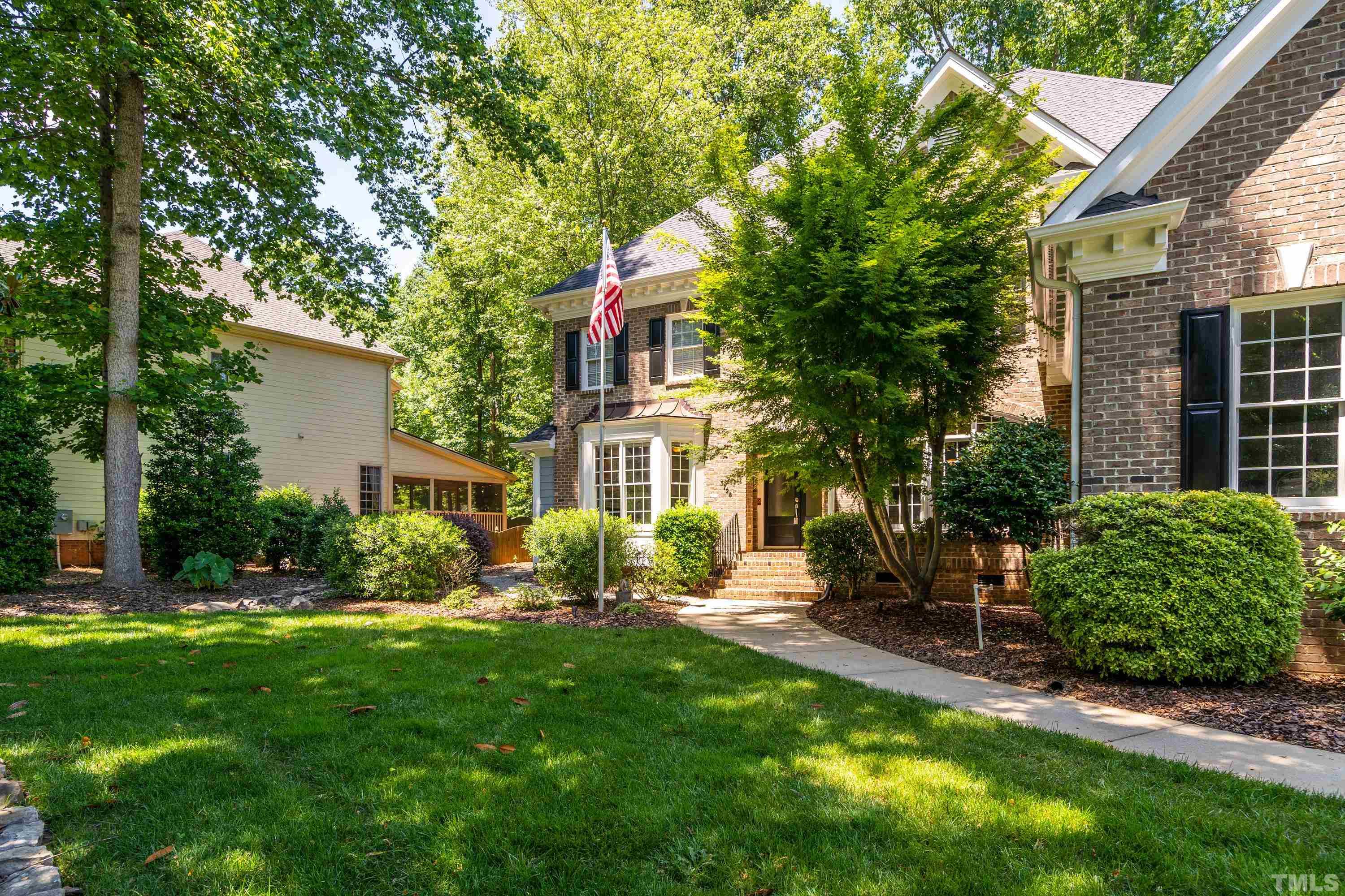 3728 Grandbridge Drive Apex, NC 27539 - Photo 9 of 76 a front view of a house with a yard and plants