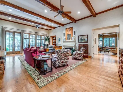 a living room with fireplace furniture and a chandelier