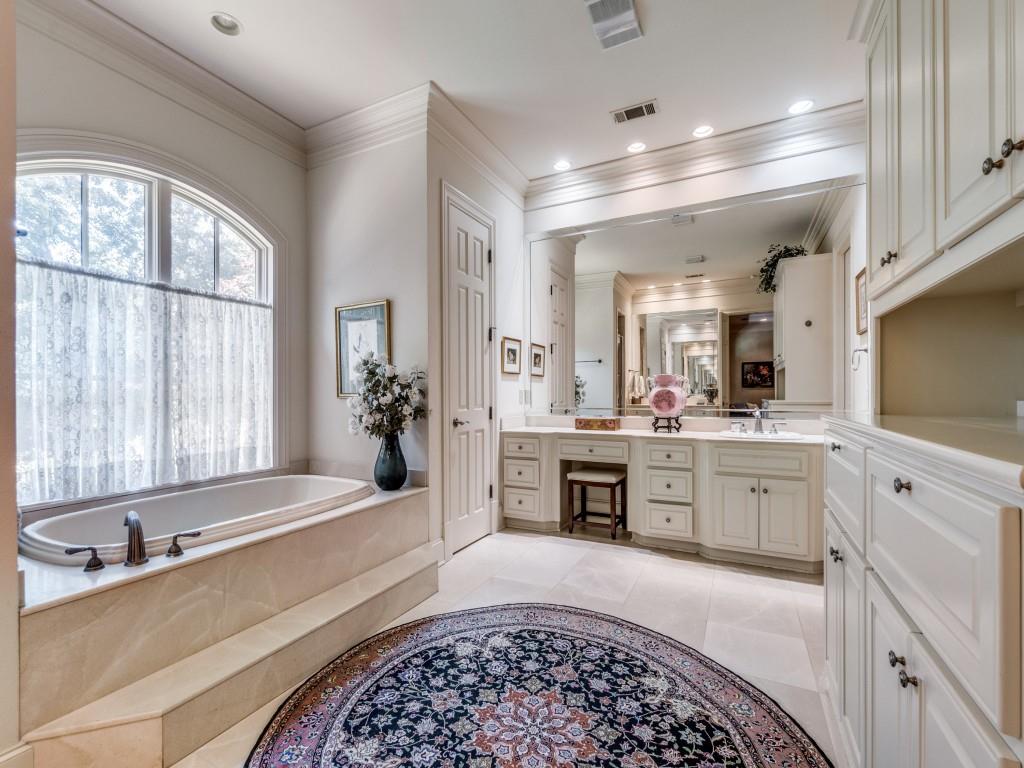 4420 Park Lane Dallas, TX 75220 - Photo 22 of 40 a large spacious bathroom with a large mirror vanity sink and bathtub