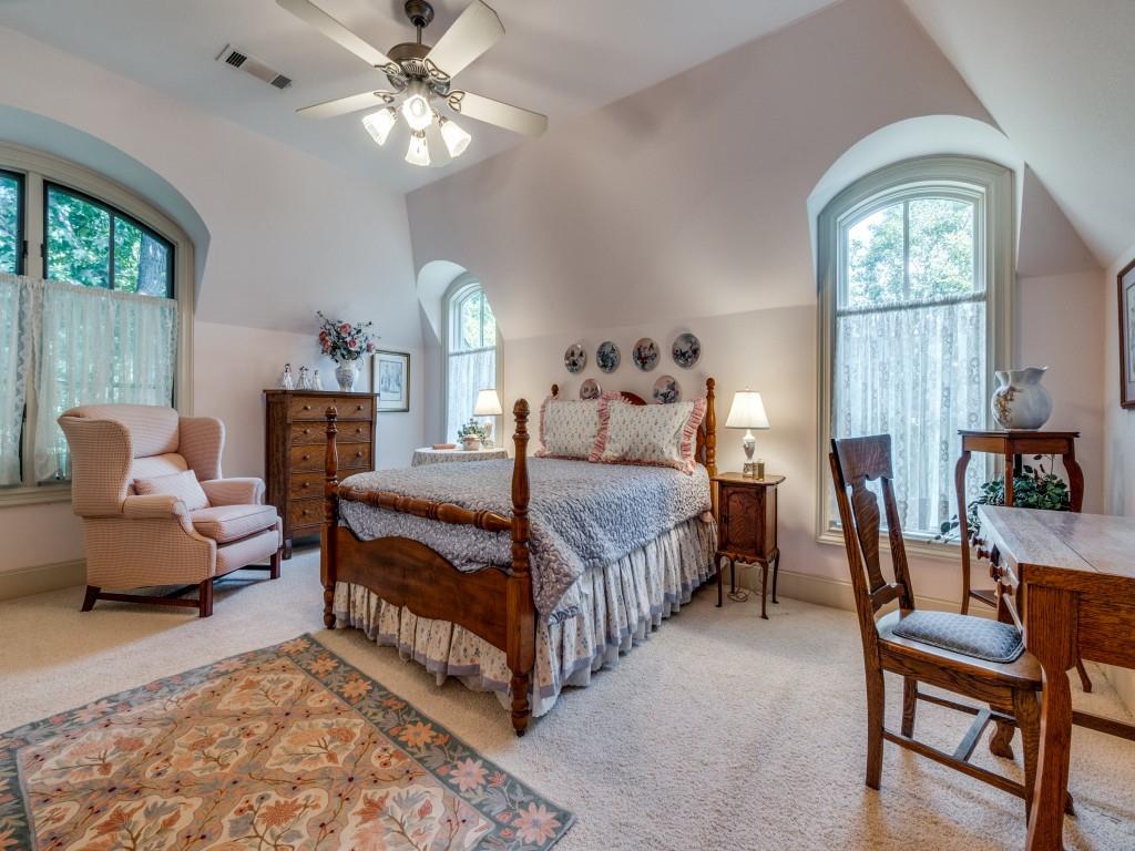 4420 Park Lane Dallas, TX 75220 - Photo 28 of 40 a bedroom with a bed and a chandelier