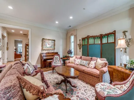 a dining room with furniture a chandelier and wooden floor