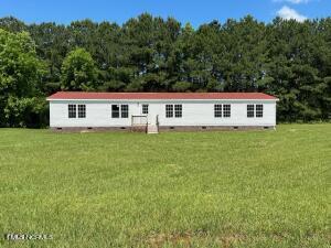 83 Ridge Lane Autryville, NC 28318 - Photo 1 of 13 a view of a house with a yard and sitting area