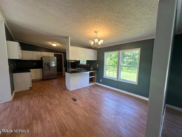 83 Ridge Lane Autryville, NC 28318 - Photo 11 of 13 a view of a kitchen with a fridge wooden floor and a kitchen