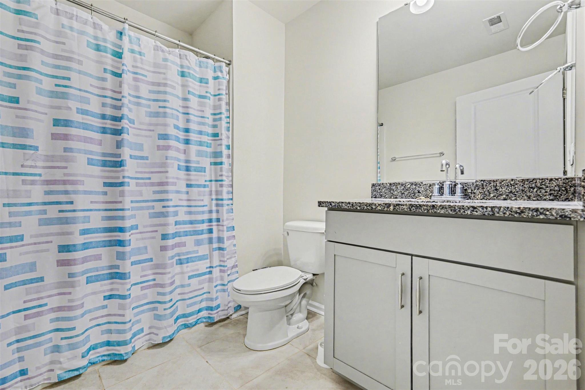 4293 Plumeria Way Fort Mill, SC 29707 - Photo 14 of 33 a bathroom with a granite countertop toilet and a sink
