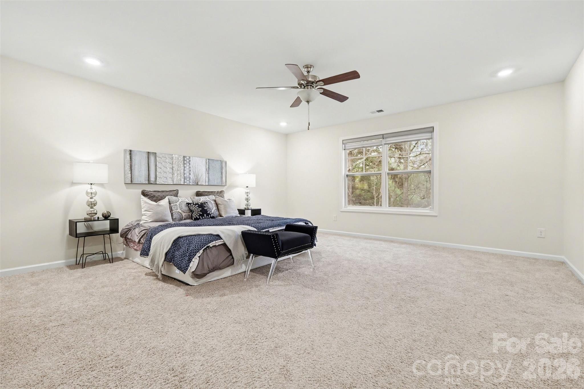 4293 Plumeria Way Fort Mill, SC 29707 - Photo 17 of 33 a spacious bedroom with a bed and window