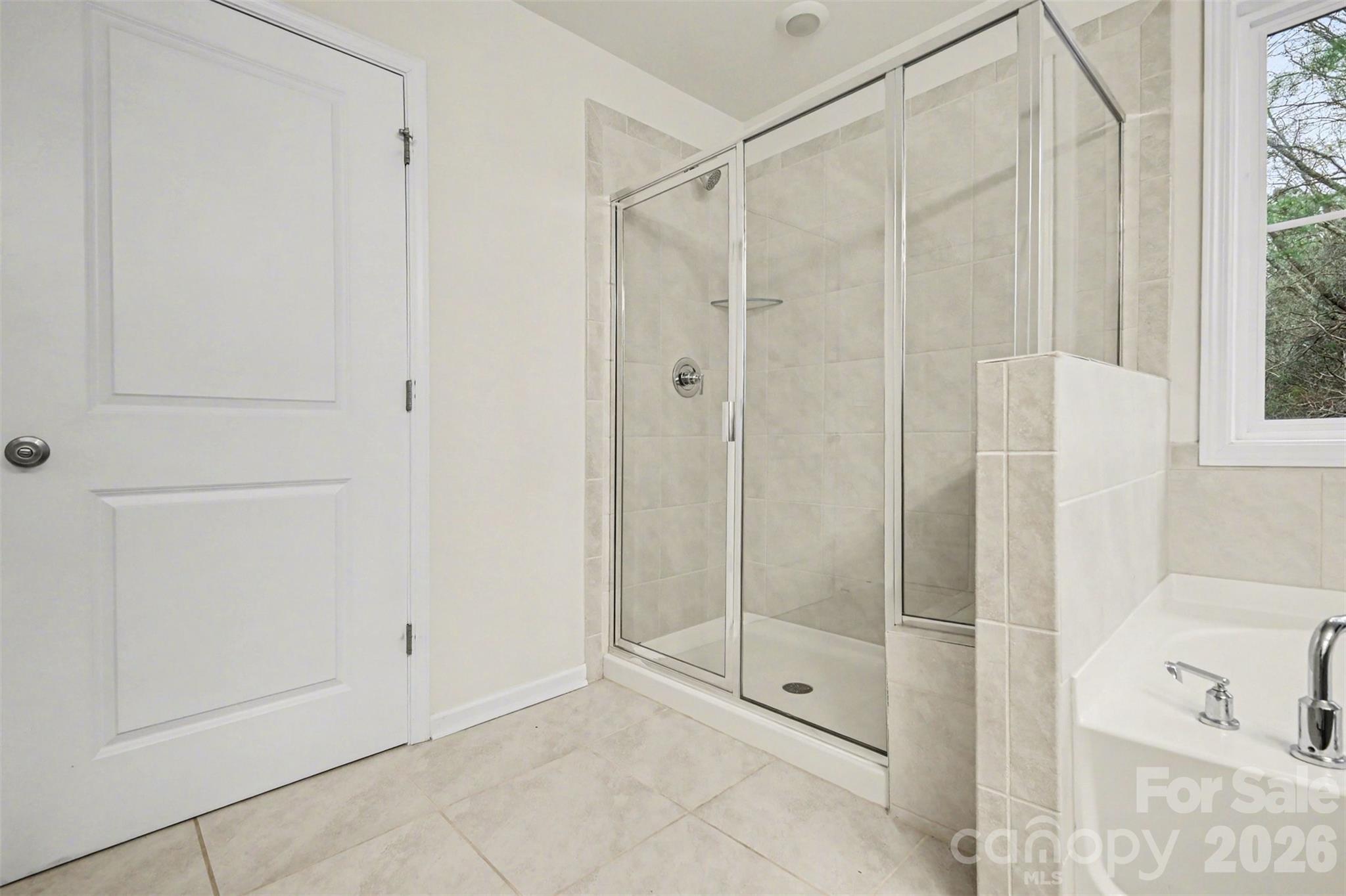 4293 Plumeria Way Fort Mill, SC 29707 - Photo 20 of 33 a bathroom with a shower and a glass door