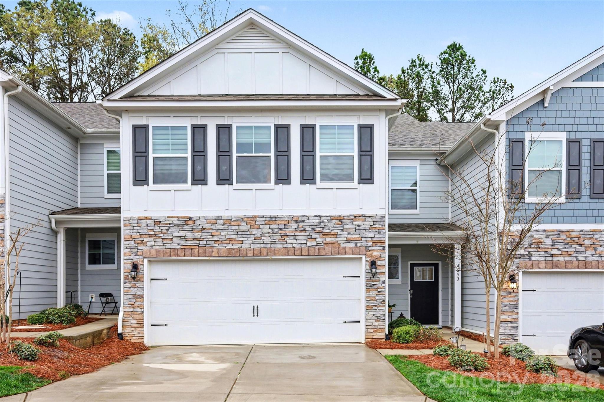 4293 Plumeria Way Fort Mill, SC 29707 - Photo 2 of 33 a front view of a house with a garden