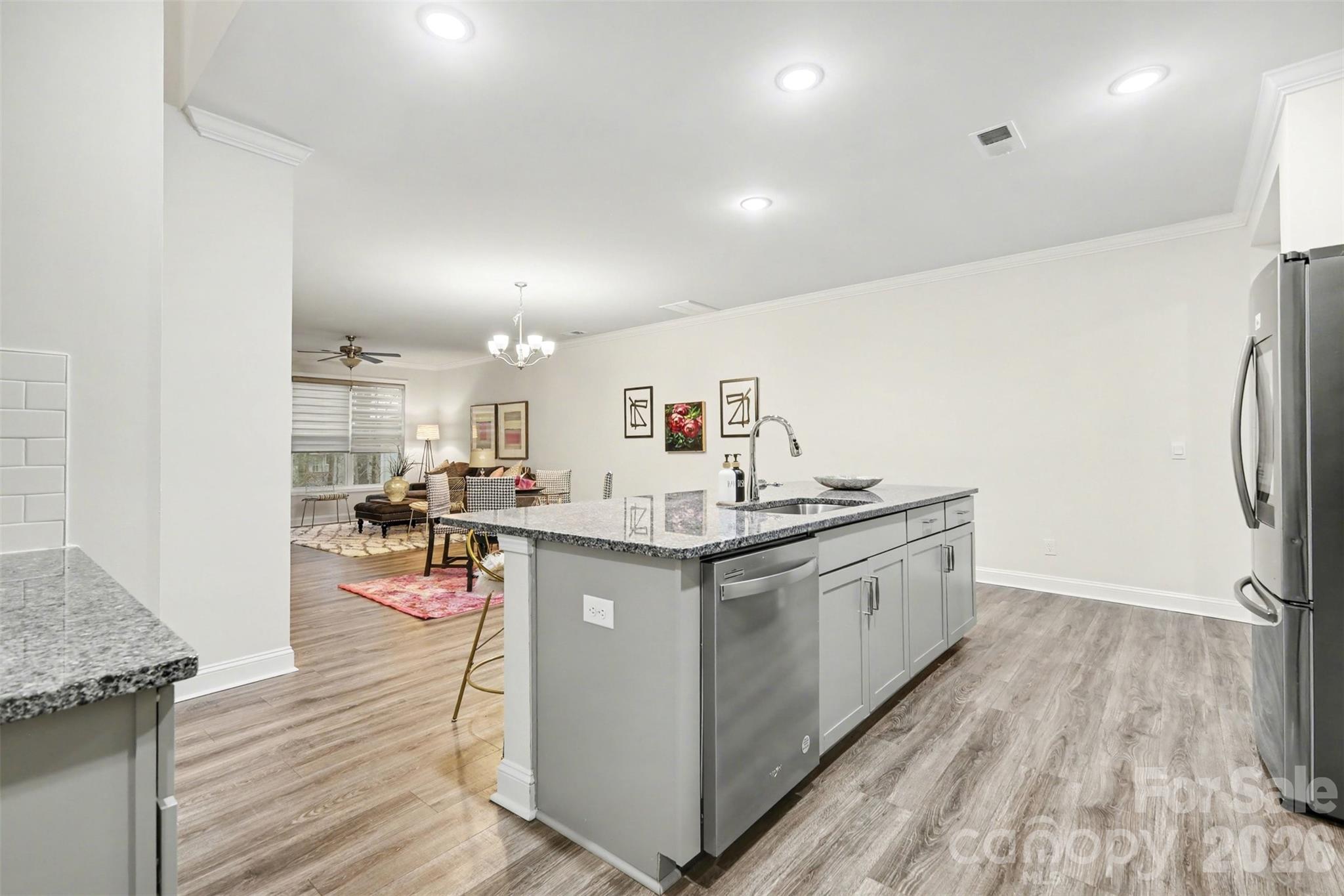 4293 Plumeria Way Fort Mill, SC 29707 - Photo 7 of 33 a kitchen with stainless steel appliances granite countertop a sink stove and refrigerator