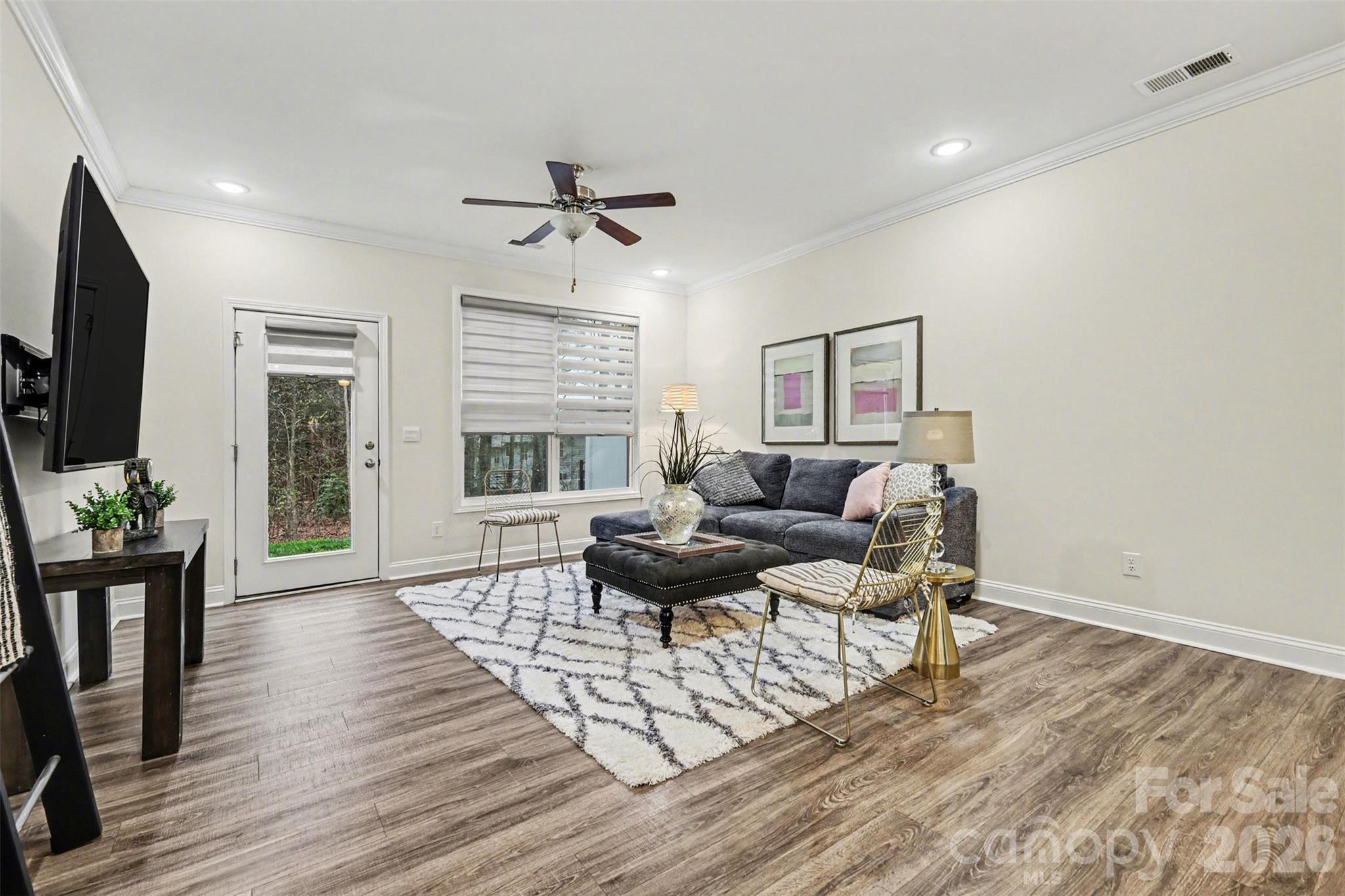 4293 Plumeria Way Fort Mill, SC 29707 - Photo 10 of 33 a living room with furniture a flat screen tv and a large window