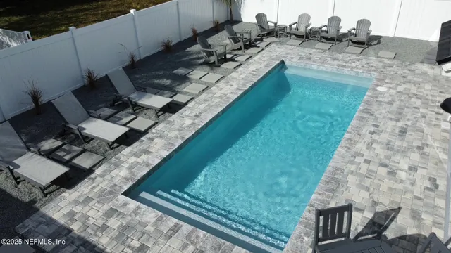 a view of a backyard with sitting area