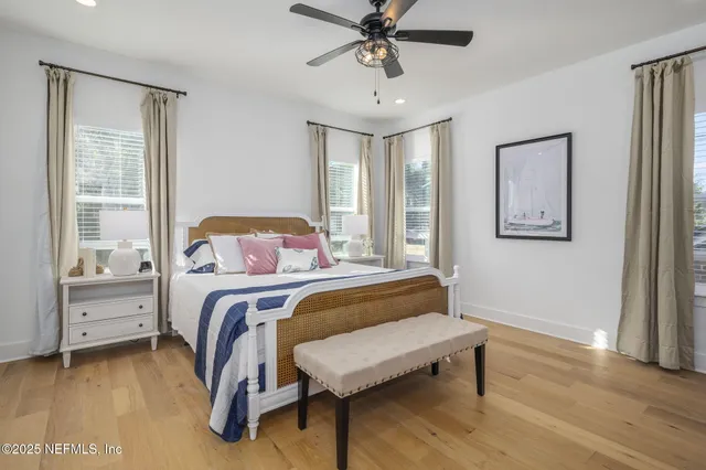 a bedroom with a bed and windows