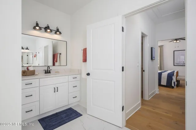 a bathroom with a sink vanity and a mirror