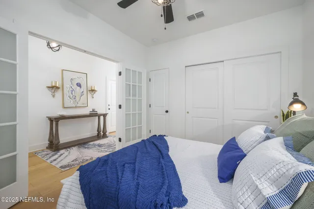 a bedroom with a bed and a painting on the wall