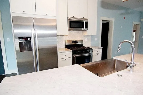 a kitchen with a refrigerator stove and microwave