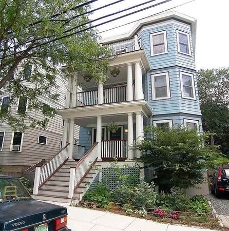 a front view of a house with a garden