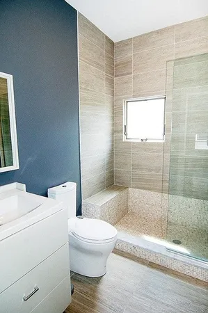 a bathroom with a toilet and a shower