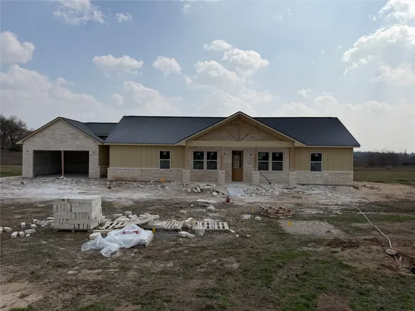 a front view of a house with yard