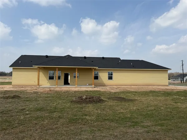 a view of a house with a yard and lake view
