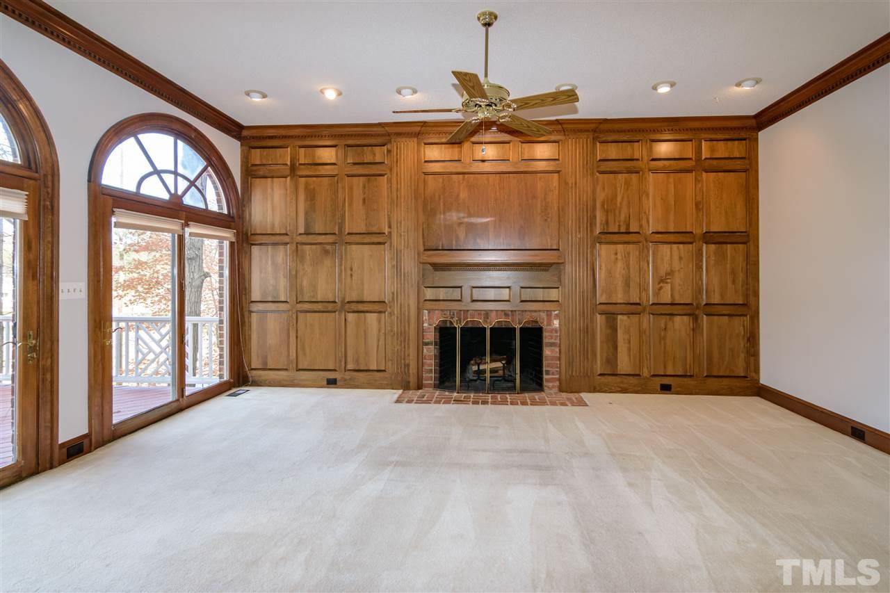 2808 Combe Hill Trail Raleigh, NC 27613 - Photo 11 of 30 a view of an empty room with a fireplace and a large window