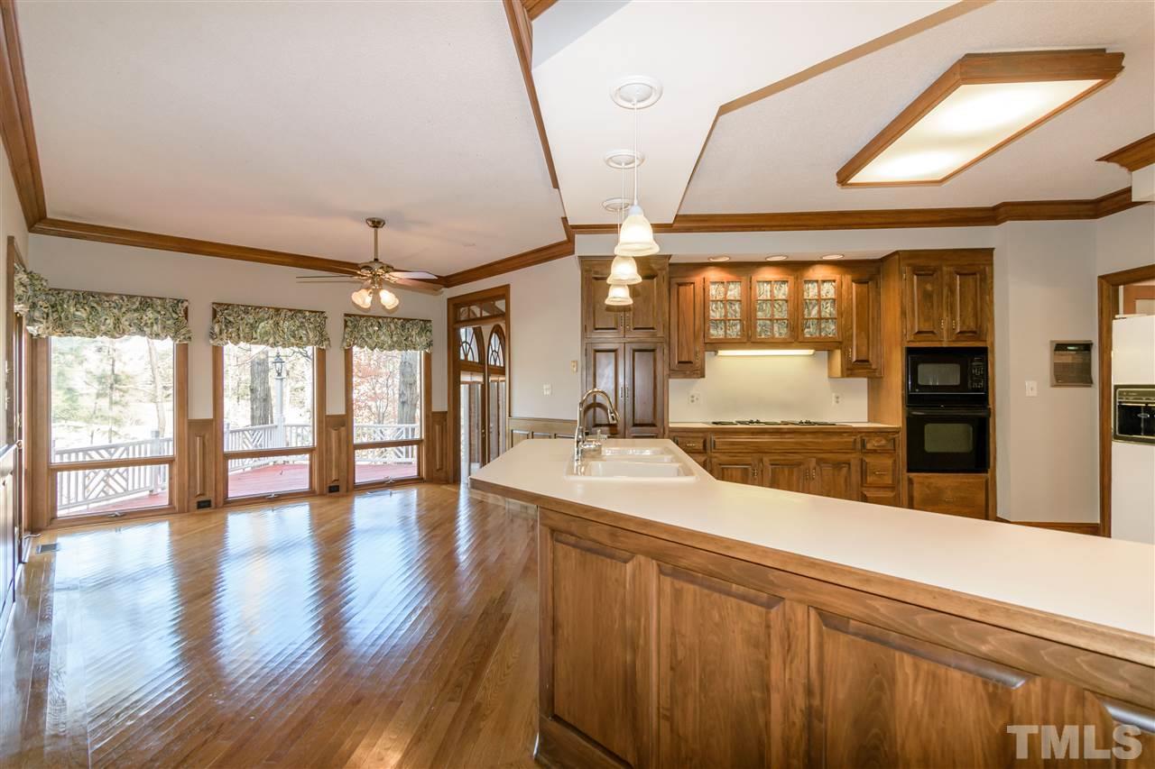 2808 Combe Hill Trail Raleigh, NC 27613 - Photo 13 of 30 a large kitchen with stainless steel appliances wooden floor and a large window