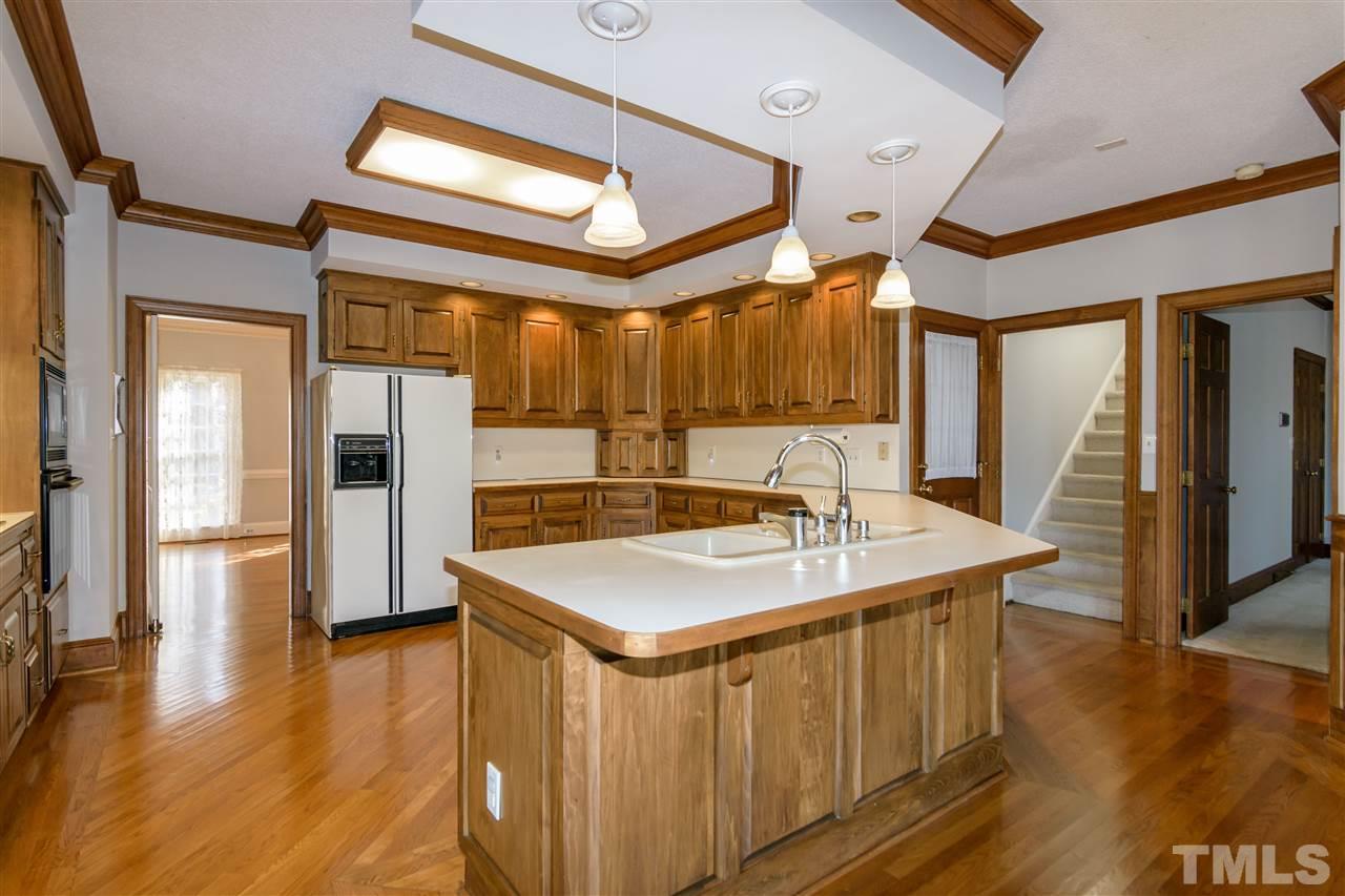 2808 Combe Hill Trail Raleigh, NC 27613 - Photo 14 of 30 a kitchen with stainless steel appliances granite countertop a sink and a refrigerator