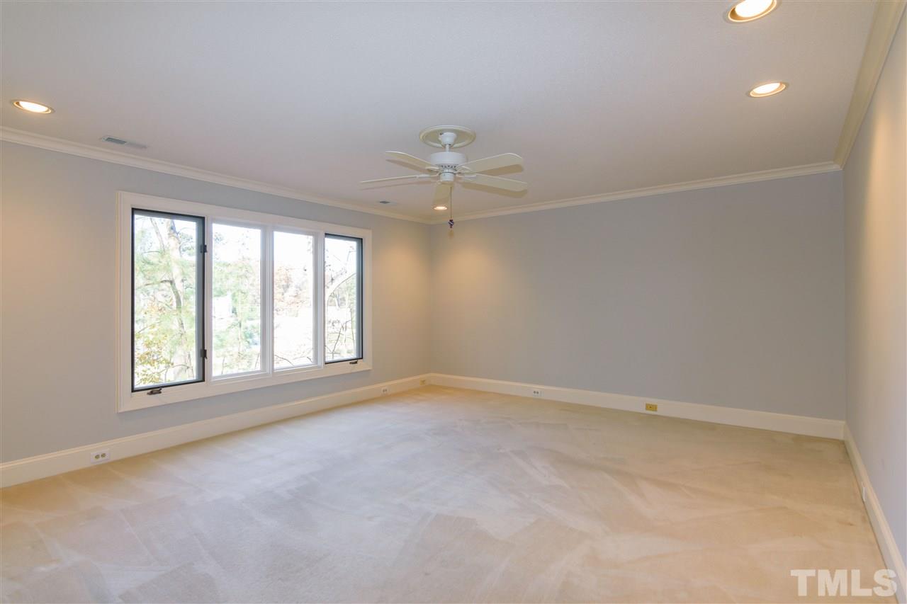 2808 Combe Hill Trail Raleigh, NC 27613 - Photo 19 of 30 an empty room with a window and a fan