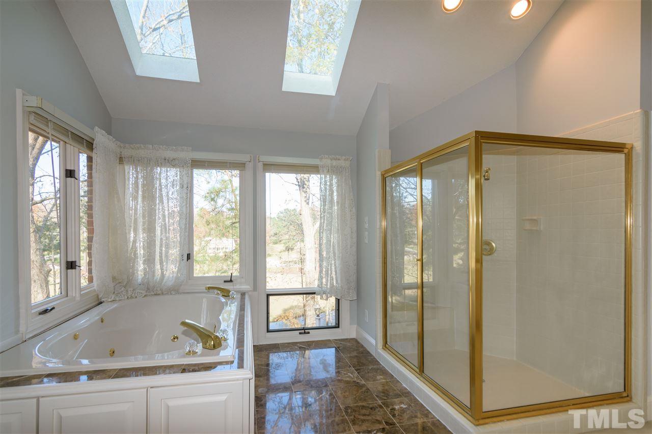 2808 Combe Hill Trail Raleigh, NC 27613 - Photo 20 of 30 a bathroom with a tub and shower