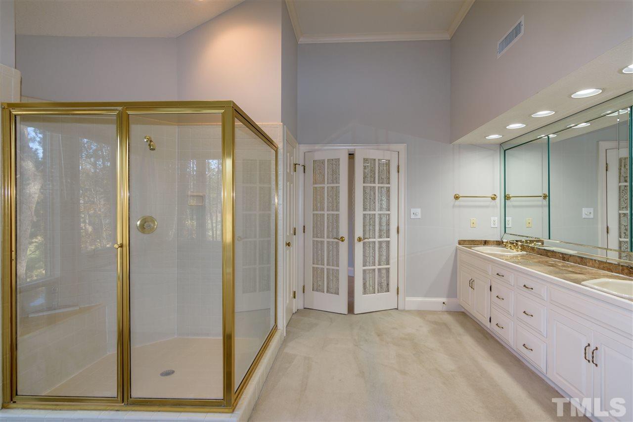 2808 Combe Hill Trail Raleigh, NC 27613 - Photo 21 of 30 a bathroom with a double vanity sink and a mirror