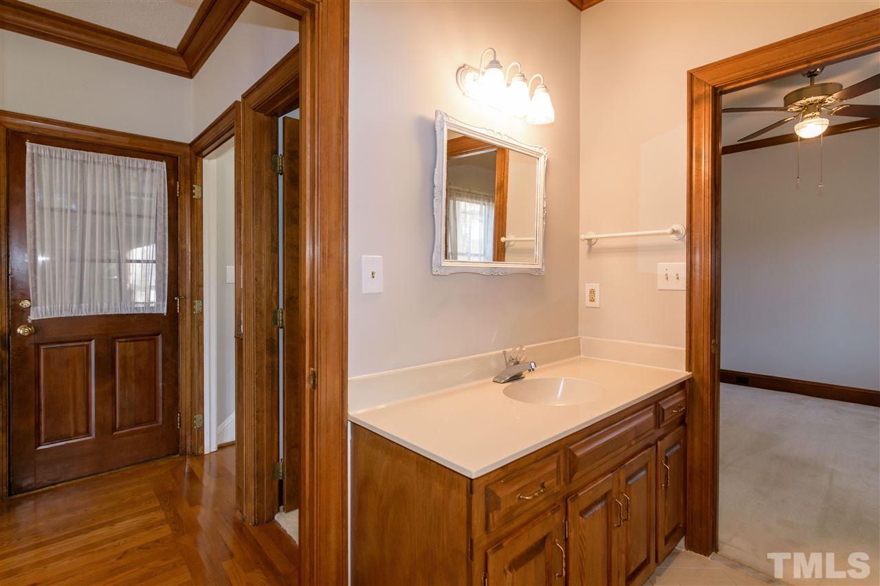 2808 Combe Hill Trail Raleigh, NC 27613 - Photo 23 of 30 a bathroom with a sink and a mirror