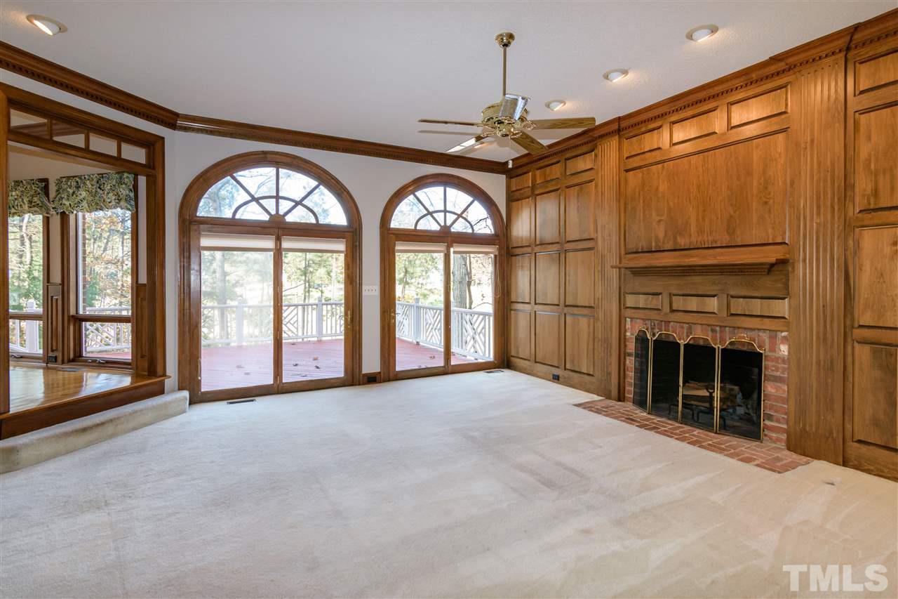 2808 Combe Hill Trail Raleigh, NC 27613 - Photo 9 of 30 a view of an empty room with a fireplace and a large window