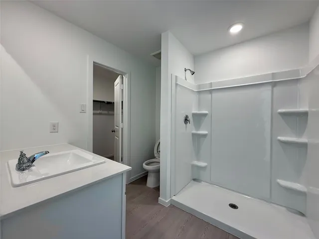 a bathroom with a sink toilet and shower