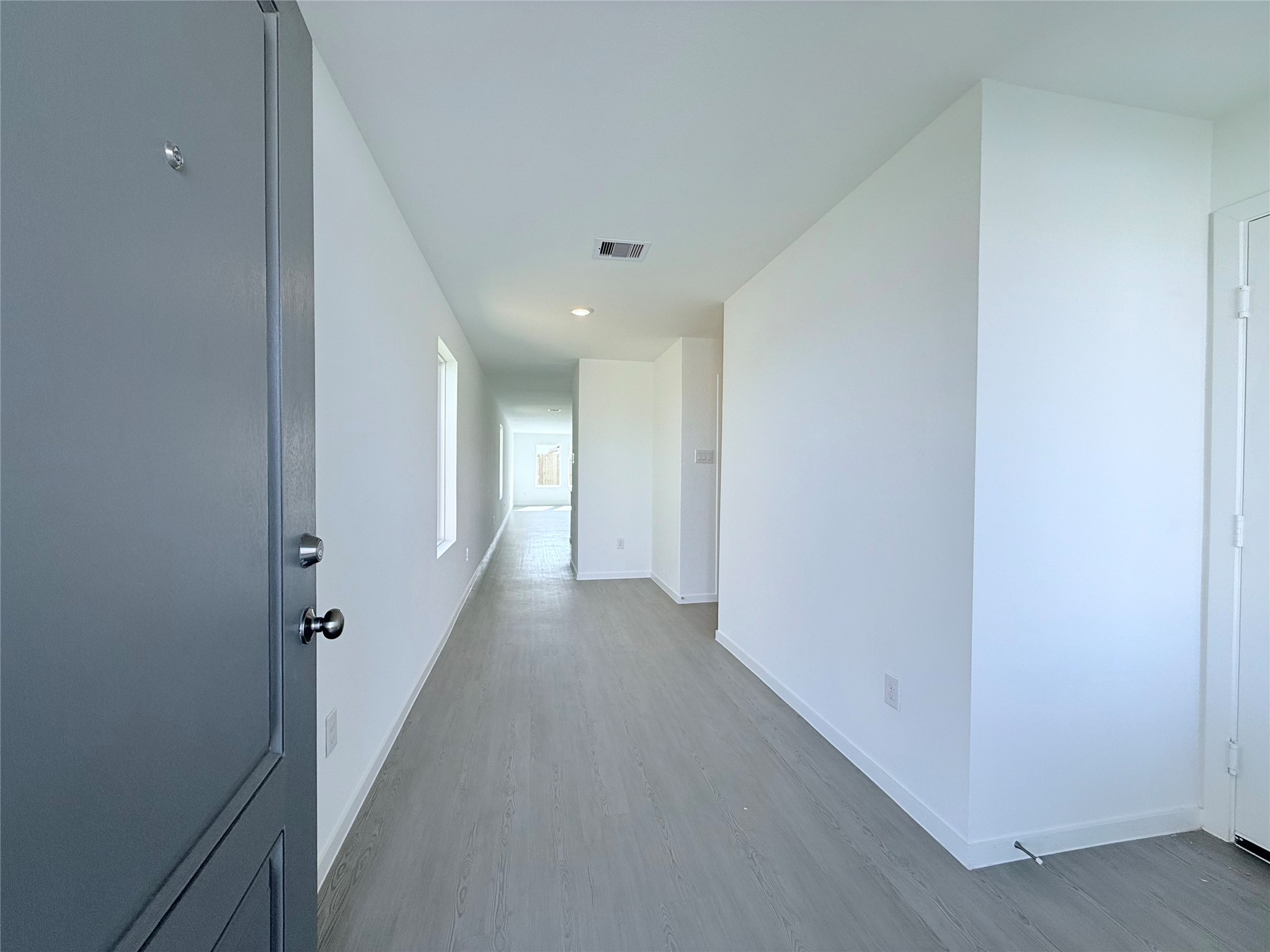 26707 Feather Reed Drive Katy, TX 77493 - Photo 4 of 18 a view of a hallway with wooden floor