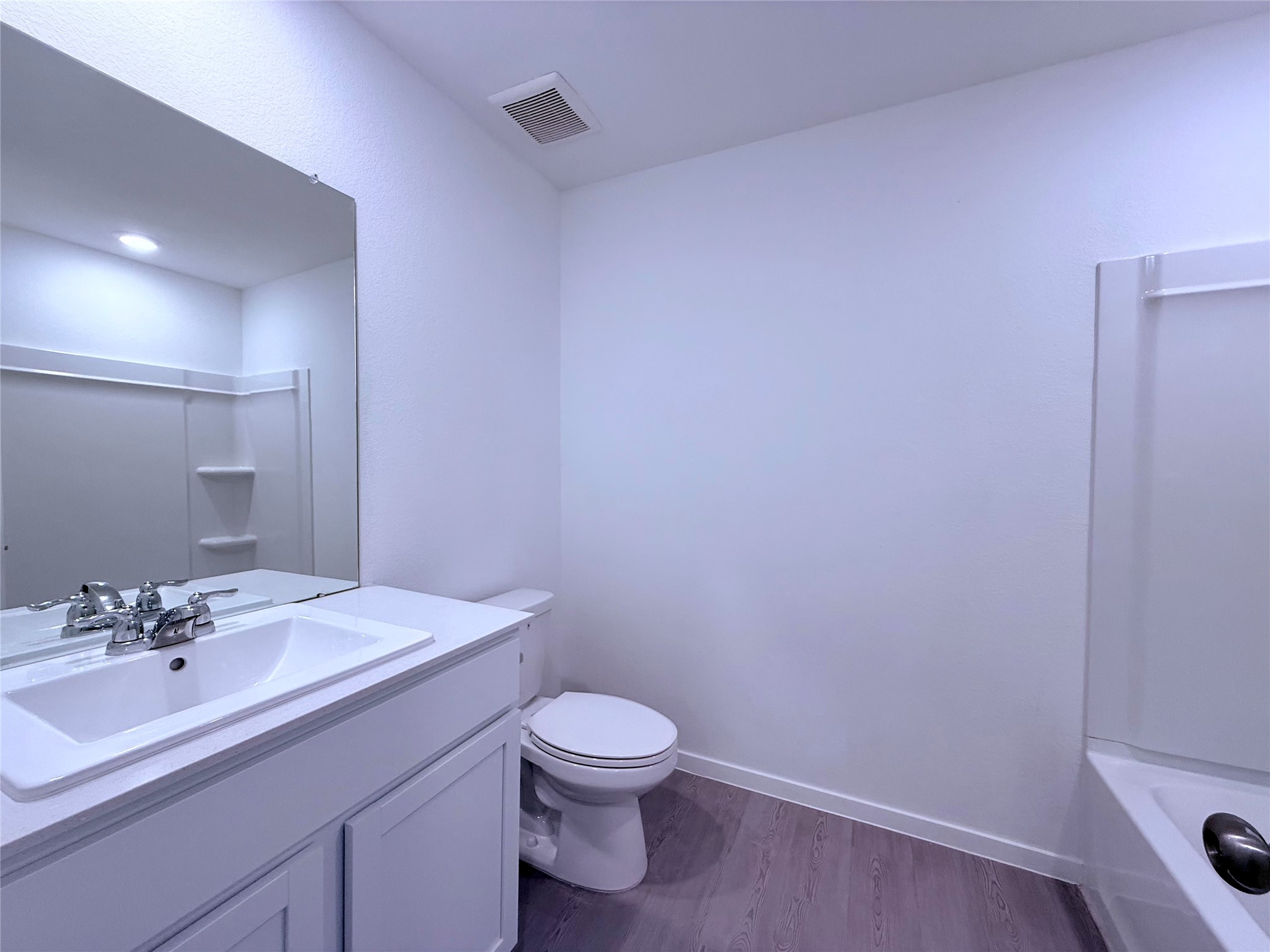 26707 Feather Reed Drive Katy, TX 77493 - Photo 6 of 18 a bathroom with a sink a toilet and a mirror