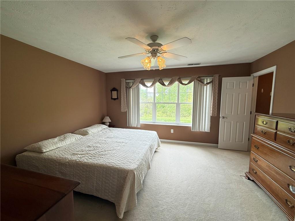 411 Chestnut Lane Apollo, PA 15613 - Photo 7 of 38 a spacious bedroom with a bed and a chandelier