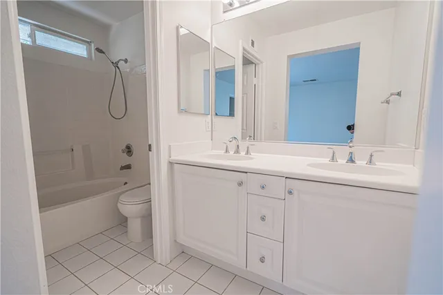 a bathroom with a granite countertop sink a toilet and shower