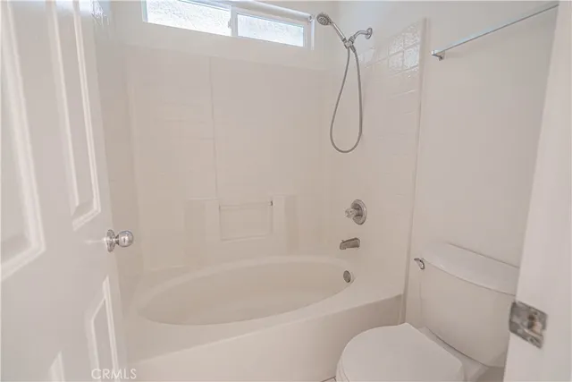 a bathroom with a bath tub with a shower