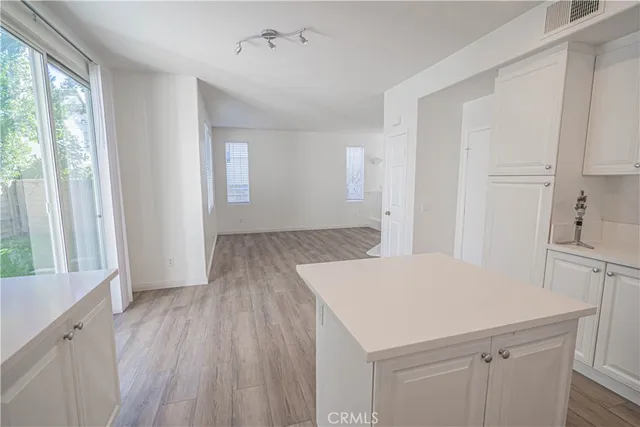 a kitchen with a wooden floor and window