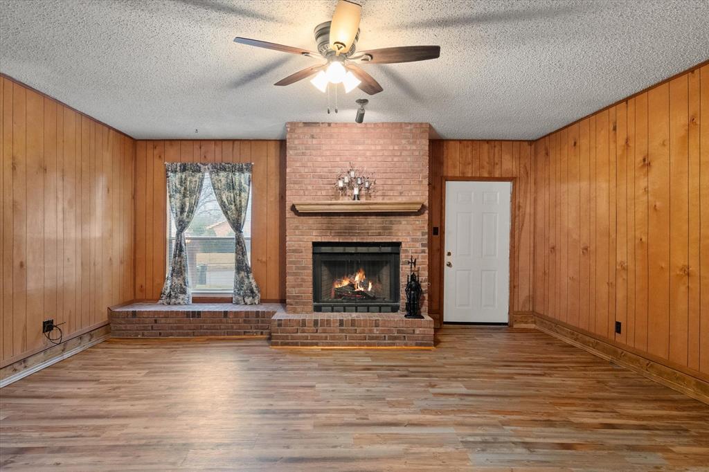 2305 Gilbert Circle Arlington, TX 76010 - Photo 13 of 38 a view of an empty room with a fireplace and a window