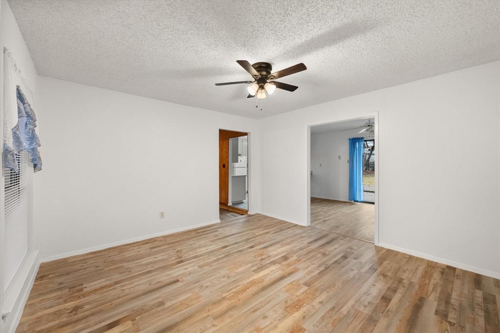 2305 Gilbert Circle Arlington, TX 76010 - Photo 18 of 38 a view of empty room with wooden floor and ceiling fan