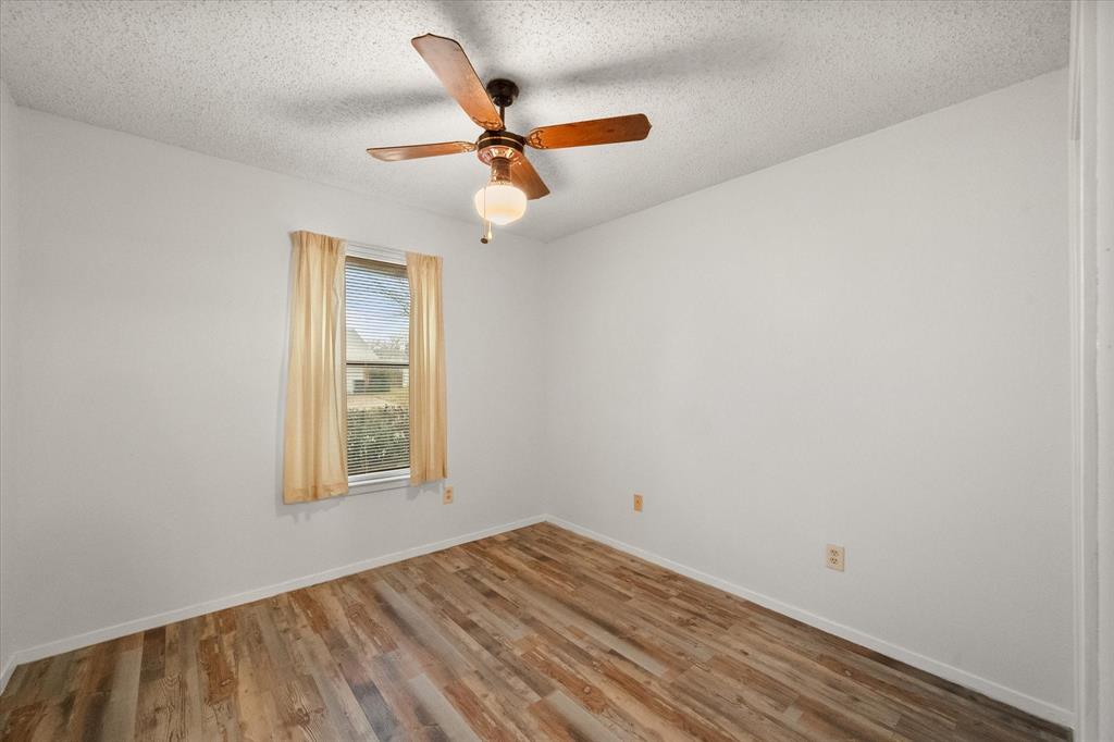 2305 Gilbert Circle Arlington, TX 76010 - Photo 19 of 38 an empty room with a window and a ceiling fan